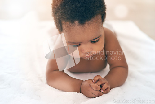 Image of Girl, blanket and kids with a black baby in a home, lying on the floor for growth or child development. Relax, children and family home with a newborn infant playing in the living room of a house