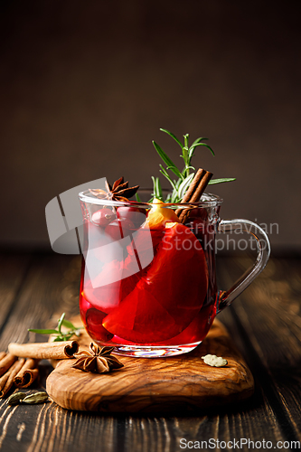 Image of Christmas mulled wine with cranberry, orange, cinnamon, anise and rosemary. Traditional hot drink or beverage, festive Xmas or New Year winter cocktail