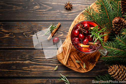 Image of Christmas mulled wine with cranberry, orange, cinnamon, anise and rosemary. Traditional hot drink or beverage, festive Xmas or New Year winter cocktail