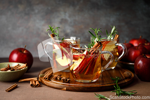 Image of Christmas mulled apple cider with cinnamon, anise and rosemary. Traditional hot drink or beverage, festive Xmas or New Year winter cocktail