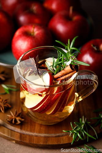 Image of Christmas mulled apple cider with cinnamon, anise and rosemary. Traditional hot drink or beverage, festive Xmas or New Year winter cocktail