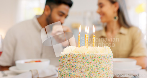 Image of Cake, anniversary or birthday, couple celebrate and romantic together, kiss and love during dinner date. Young, man and woman, relationship growth and spending quality time, food and dessert to enjoy
