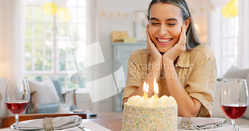 Image of Couple, birthday and cake with kiss, blowing candles and hug, smile and clapping at a party in home. Happy latino man and woman with celebration, surprise and gift with romance, love and happiness