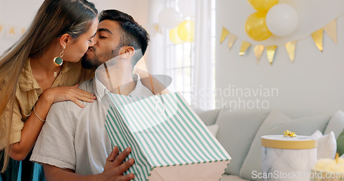 Image of Surprise gift, present bag and happy couple for birthday celebration in home living room with love, kiss and excited. Girlfriend giving box for birthday party together for date, discount and commerce