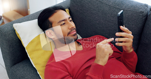 Image of Social media, relax and man texting on sofa, laughing while watching a funny online video in his home. Comedy, comfort and communication by Indian male enjoying weekend with new subscription service