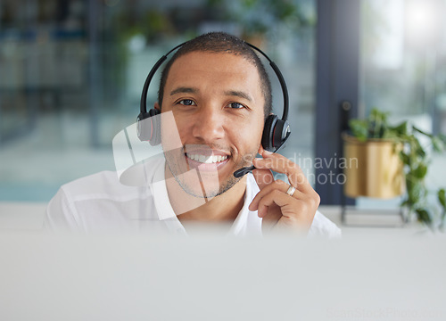 Image of Smile, talking and portrait of a man in a call center for online support, consulting and advice. Happy, conversation and face of a customer service agent working in telemarketing, sales and helpline