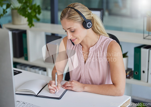 Image of Woman, call center and writing in notebook by office desk for record keeping, reminder or planning. Happy female consultant taking notes in book for customer service, support or idea to schedule task