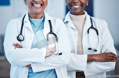 Image of Black women, doctors and healthcare workers with happiness and solidarity in a hospital. Medical care, support and teamwork of a healthcare, wellness and health team in a clinic ready for management