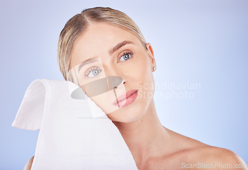 Image of Face, beauty and woman with towel to wipe in studio isolated on a purple background. Thinking, makeup cosmetics and skincare of female model with fabric or cloth for facial wiping for healthy skin.