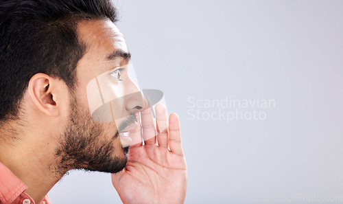 Image of Whisper, talking and asian man with a secret on mockup isolated on a grey studio background. Announcement, space and guy speaking, sharing opinion and gossip for discussion and communication