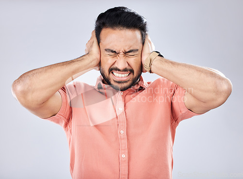 Image of Loud, mental health and angry Asian man with schizophrenia isolated on a grey studio background. Stress, fear and scared guy closing ears for noise, scared and bipolar pressure on a backdrop