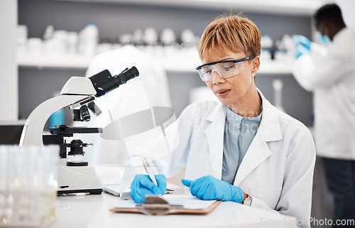 Image of Scientist, woman and writing lab report with results, focus or analysis for pharma development. Science expert, checklist and documents with microscope, innovation and results of pharmaceutical trial