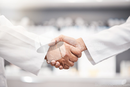 Image of Closeup, handshake and doctors with collaboration, research and partnership for healthcare. Zoom, hand and scientists with agreements, teamwork for wellness or update for data analytics in laboratory