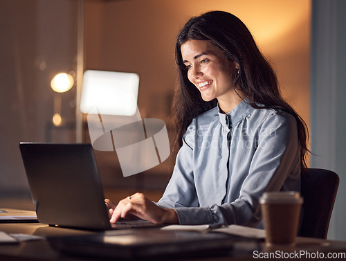 Image of Business woman, computer typing and dark office with tax audit deadline with happiness. Corporate employee, working and happy accountant planning a online finance strategy with a laptop and a smile