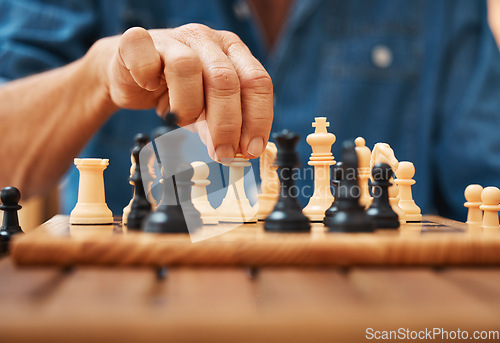 Image of Play, chess and hands with a king on a board game with a strategy in tournament in home. Checkmate, chessboard and smart man or male playing in a sports contest or problem solving challenge for mind.