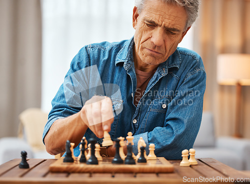 Image of Chess, play and senior man with board game piece while practicing strategy in home alone. Checkmate, chessboard and retired male playing sports and thinking for problem solving challenge in house.