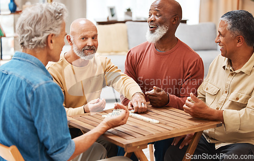 Image of Senior men, friends and dominoes in board games on wooden table for activity, social bonding or gathering. Elderly group of domino players having fun playing and enjoying entertainment at home