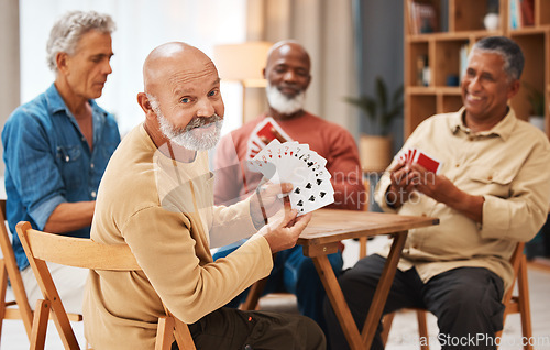 Image of Showing, portrait and senior friends with cards for a game, playing and bonding in a house. Smile, show and elderly group of men in a nursing home for poker, games and competitive for fun together