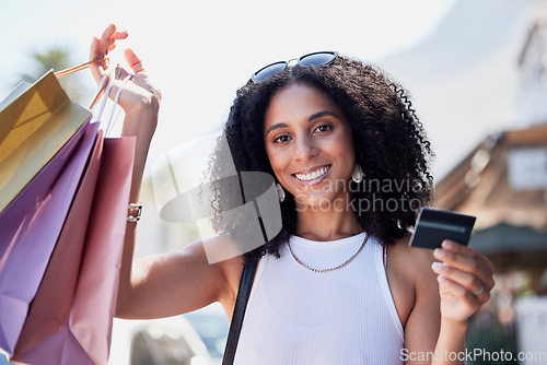 Image of Black woman, portrait or shopping bags with credit card in city for clothes sales, fashion deals or discount payment. Smile, happy or retail customer with banking budget, gifts or promotion present