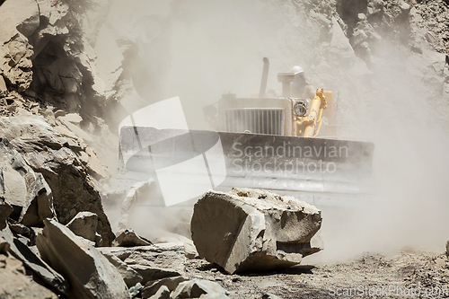 Image of Bulldozer cleaning landslide on road in Himalayas