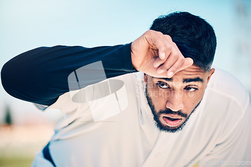 Image of Tired, sweat and baseball man at a field for training, break and breathing after game fatigue. Athletic, sports and indian guy stop to breathe after exercise, workout or match practice