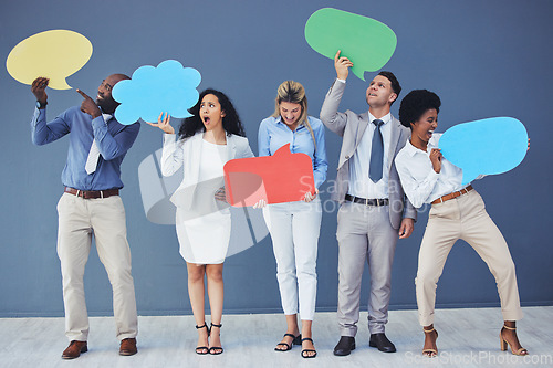 Image of Speech bubble, team and comment by business people holding sign, news and voice icon feeling excited on social media. Group, opinion and poll by employees with mockup space in studio blue background