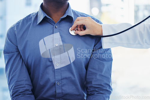 Image of Doctor, patient and consultation with stethoscope on heart in hospital for healthcare or health insurance. Black man and cardiology person check lungs, breathing and wellness of body and organ