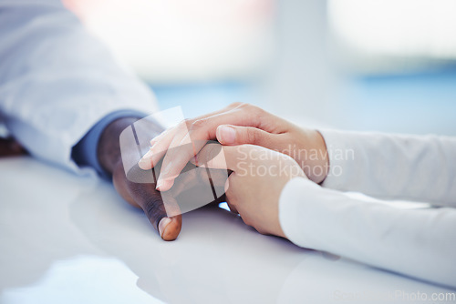 Image of Hands, healthcare or comfort with a doctor and patient in a hospital during an appointment or checkup. Medical, support and trust with a medicine professional showing empathy while consulting