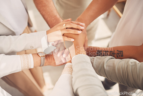 Image of Business women, hands together and unity above in partnership or trust for teamwork, collaboration or support at office. Woman group piling hand in team building for cooperation, motivation or union