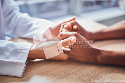 Image of Holding hands, cancer and doctor in support of patient for comfort, trust and help in a hospital or clinic office. Closeup, care and healthcare professional consulting a person for medical advice