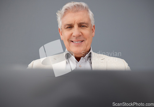 Image of Senior, computer and professional business man isolated on a gray background for online planning and market research. Corporate person, boss or executive working on laptop tech for asset management