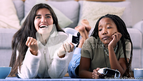 Image of Gaming, winner and women playing a video game and girl celebrating in a home, house or apartment. Friends, console and people with joystick and jealous person due to victory with controller