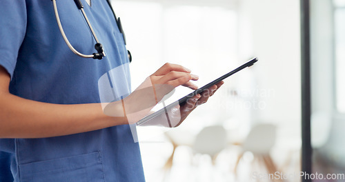 Image of Digital tablet, healthcare and doctor doing research in the hospital before a consultation. Technology, nurse or medical worker scrolling on mobile device to analyze test results in a medicare clinic