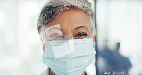 Image of Covid, face mask and senior doctor in hospital for healthcare, safety or wellness. Leadership, corona or portrait of female, woman or medical physician in ppe prepared to tackle the covid 19 pandemic