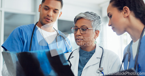 Image of Doctor, x ray and collaboration with a woman surgeon and team talking about diagnosis in a hospital. Medical, teamwork and healthcare with a female medicine professional training interns in a clinic