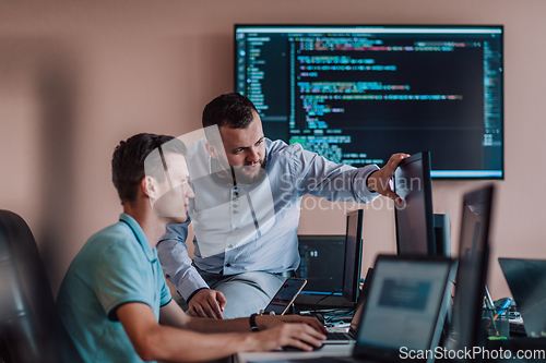 Image of Programmers engrossed in deep collaboration, diligently working together to solve complex problems and develop innovative mobile applications with seamless functionality.