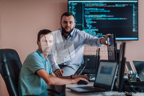 Image of Programmers engrossed in deep collaboration, diligently working together to solve complex problems and develop innovative mobile applications with seamless functionality.