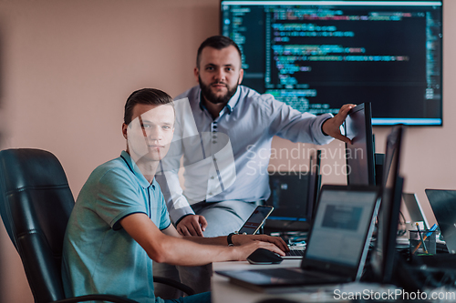 Image of Programmers engrossed in deep collaboration, diligently working together to solve complex problems and develop innovative mobile applications with seamless functionality.