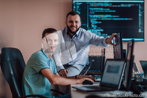 Image of Programmers engrossed in deep collaboration, diligently working together to solve complex problems and develop innovative mobile applications with seamless functionality.