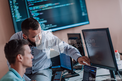 Image of Programmers engrossed in deep collaboration, diligently working together to solve complex problems and develop innovative mobile applications with seamless functionality.