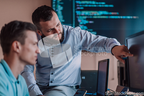 Image of Programmers engrossed in deep collaboration, diligently working together to solve complex problems and develop innovative mobile applications with seamless functionality.