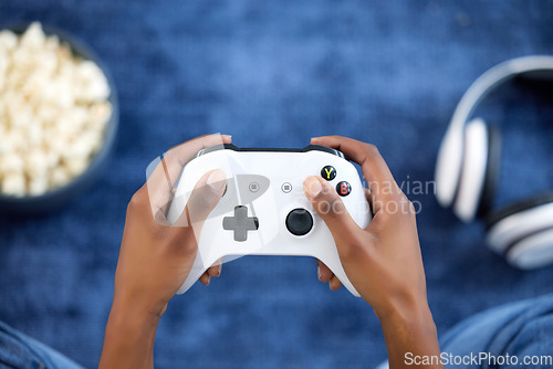 Image of Hands, video games and person playing online game on home with popcorn for gaming, gamepad and relax. Gamer woman console, joystick or control for esports, streaming and above cyber competition