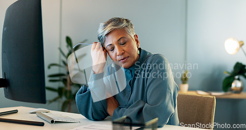 Image of Stress, headache and burnout with a business woman suffering from anxiety while working in her office. Compliance, mental health and migraine with a senior female employee feel frustrated at work