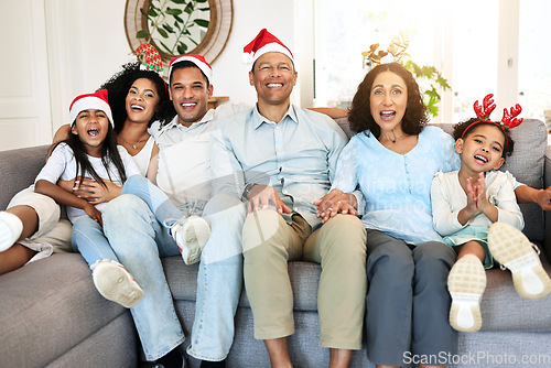 Image of Christmas, portrait and smile of big family on sofa in home living room, bonding and laughing at funny joke. Love, xmas holiday and care of happy children, parents and grandparents sitting on couch.