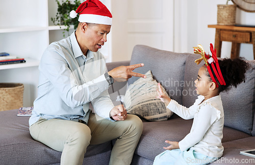 Image of Senior family and kid play Christmas game together for fun, learning and bonding with numbers education. Grandfather or mature man talking and teaching girl child in lounge for thanksgiving holiday