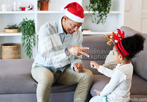 Image of Rock, paper, scissors at Christmas with a father and daughter in the living room of their home together. Black family, love or bonding with a man and girl child playing games in their house