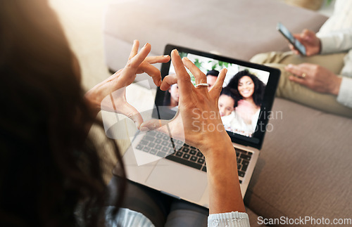 Image of Hand heart, video call and love with laptop screen, family and communication with emoji, connection and bonding. Hands, relax at home and happy with care, connectivity and virtual chat in lounge