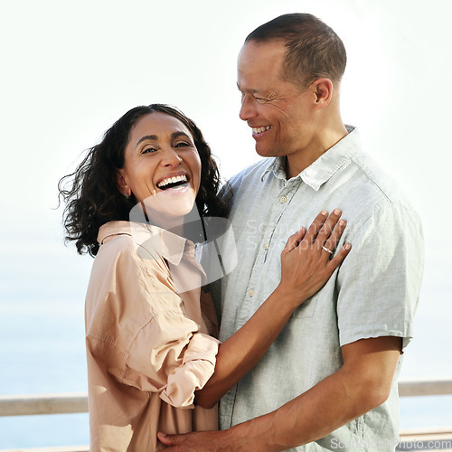 Image of Portrait, laughing and senior couple by beach, hug and enjoying quality time on holiday or vacation. Love, comic and retired happy man and woman laugh at funny joke or comedy while having fun by sea.