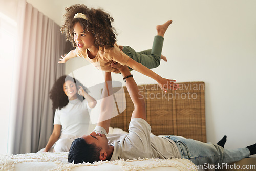 Image of Airplane, playful and girl playing with father, bonding and quality time together. Smile, happy and dad holding an adorable girl kid for play, fun and caring in the bedroom of a family home with love