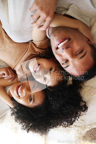 Image of Bed, top view and father, mother and girl smile for bonding, quality time and affection in morning. Big family, happy and portrait of parents with happy child in bedroom relaxing together at home